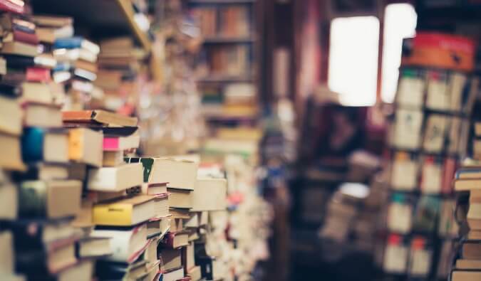 lots of books piled up in a bookshop