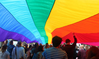 A huge rainbow flag at a gay pride parade