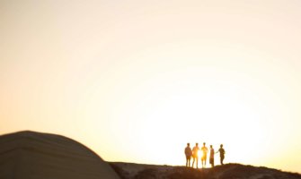 People standing on a mountain at sunrise