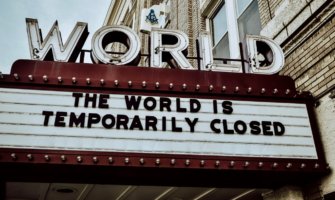 A movie theater billboard saying the world is closed