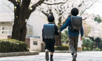 Two young Japanese students walking to school