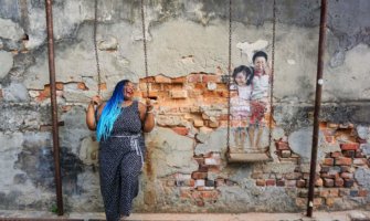 Annette posing near a mural in Penang
