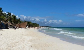A wide beach on a sunny day in Tulum, Mexico