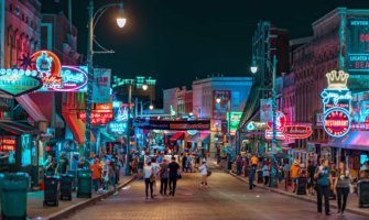 The bustling downtown core of Memphis, TN at night full of tourists and locals